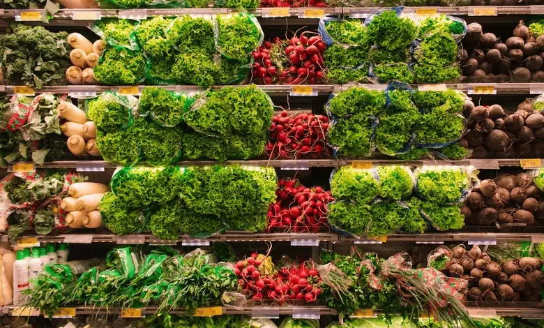 Close-up view of a produce section in a grocery store, showcasing the variety of fresh vegetables available to those facing food insecurity.