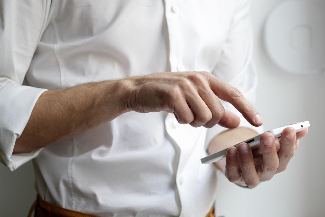 A professional man using a mobile fax app, demonstrating how it boosts productivity for business professionals.