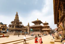 A scenic view of Patan Durbar Square in Nepal, showcasing historic temples, traditional architecture, and local visitors.