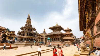 A scenic view of Patan Durbar Square in Nepal, showcasing historic temples, traditional architecture, and local visitors.