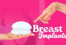 A hand points to two different types of breast implants, showcasing the variety in shape, size, and texture for augmentation.